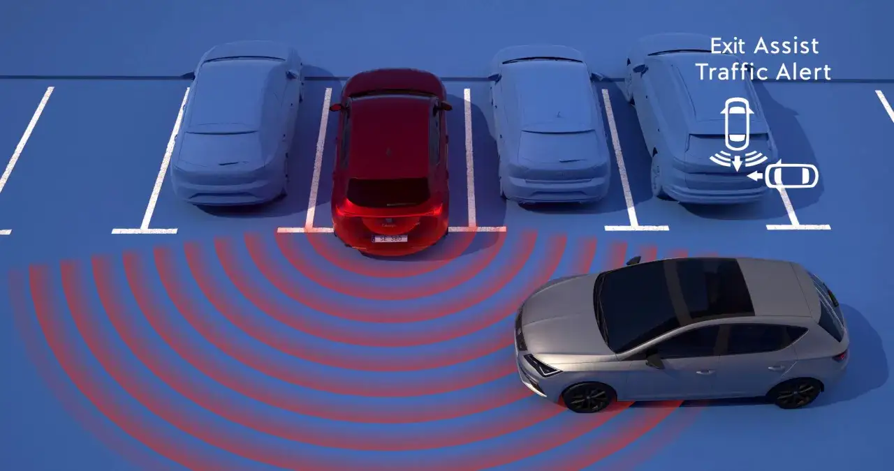 System ADAS ostrzega przed ruchem poprzecznym podczas wyjazdu z miejsca parkingowego. Czerwone fale pokazują zasięg czujników.