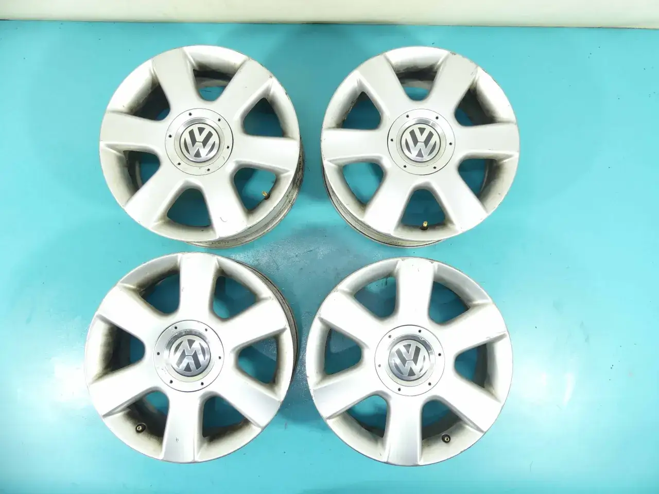 Cztery felgi aluminiowe do VW Golf 5, z charakterystycznym rozstawem śrub.